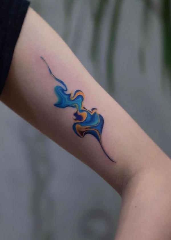 Colored smoke bicep tattoo
