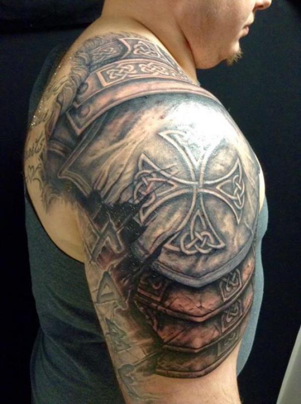 Cross shield tattoo on shoulder