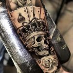 Crowned skull and ace of spade with white rose tattoo forearm