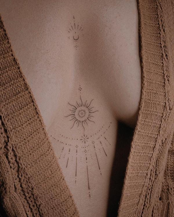 Dainty sunburst sternum tattoo