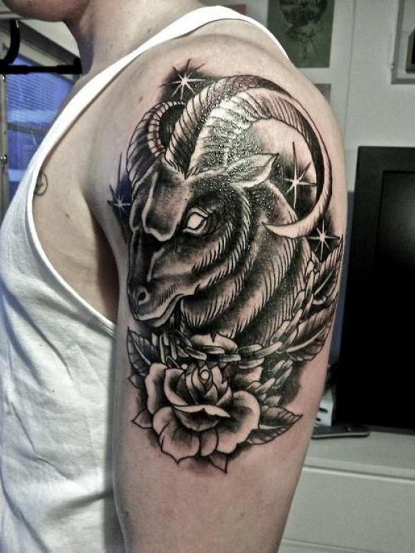 Dark Capricorn goat with rose tattoo half sleeve