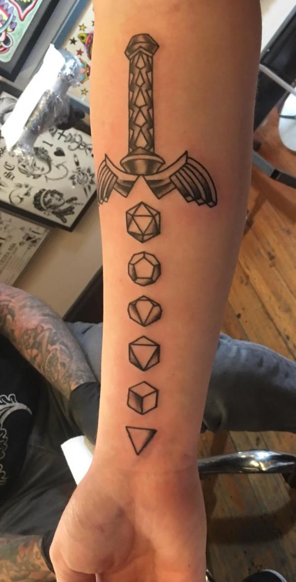 Dice sword forearm tattoo black and grey