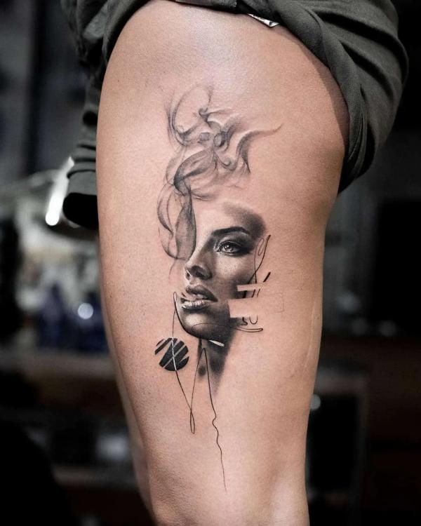 Female smoke thigh tattoo