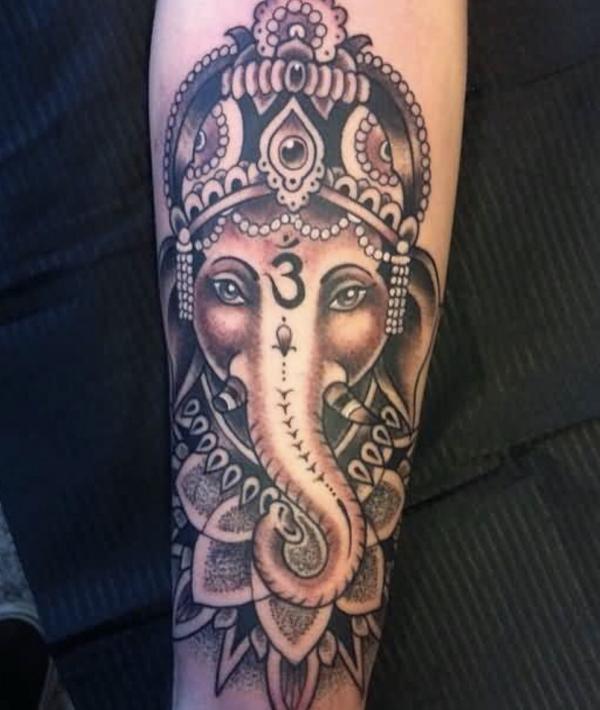 Feminine elephant face with OM tatoo