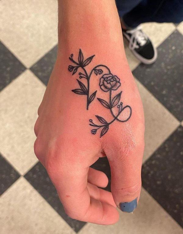 Floral Capricorn sign hand tattoo