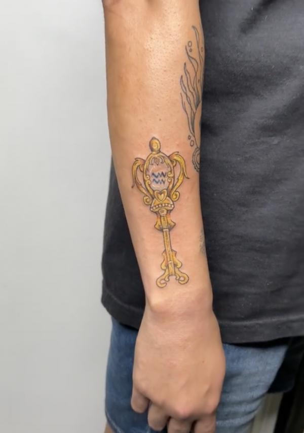 Forearm Aquarius key tattoo