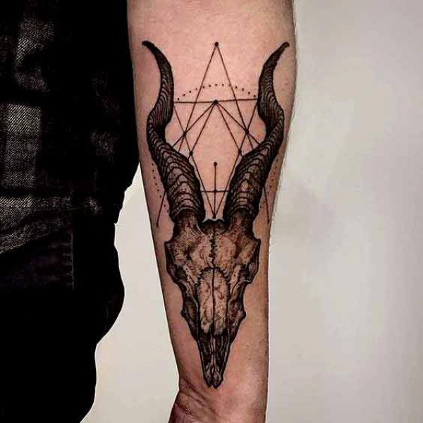 Geometric Capricorn goat skull tattoo forearm