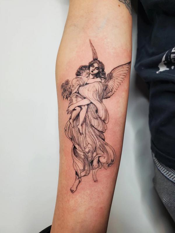 Guardian angel holding a baby tattoo on inner forearm