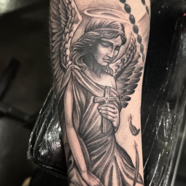 Guardian angel with a cross tattoo