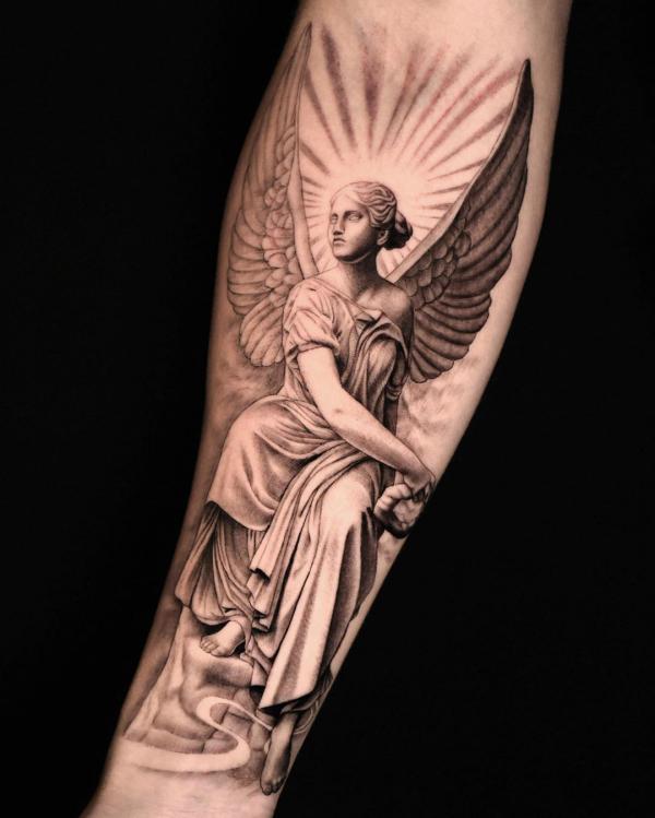 Guardian angel with halo tattoo on inner forearm