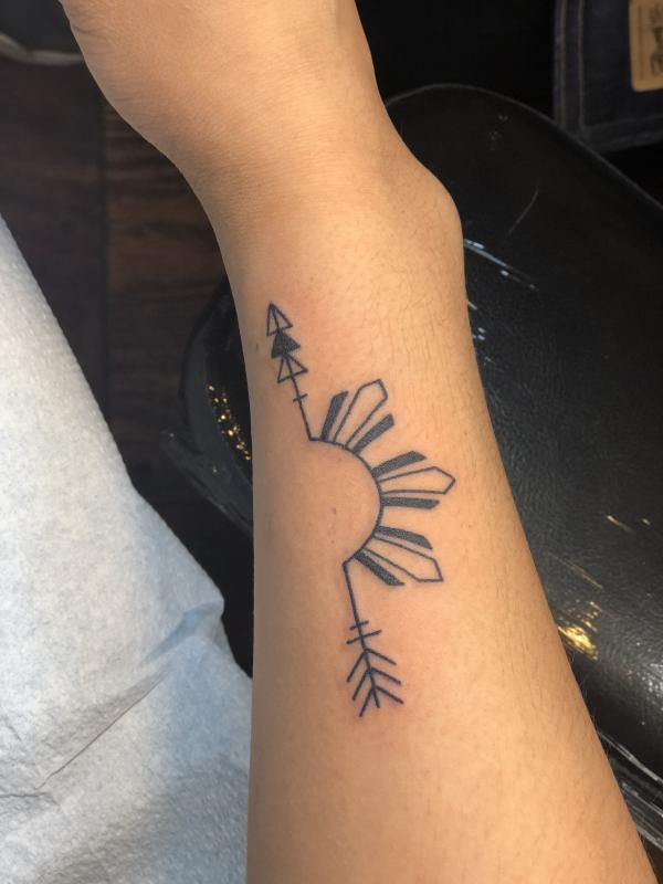 Half filipino sun with arrow tattoo