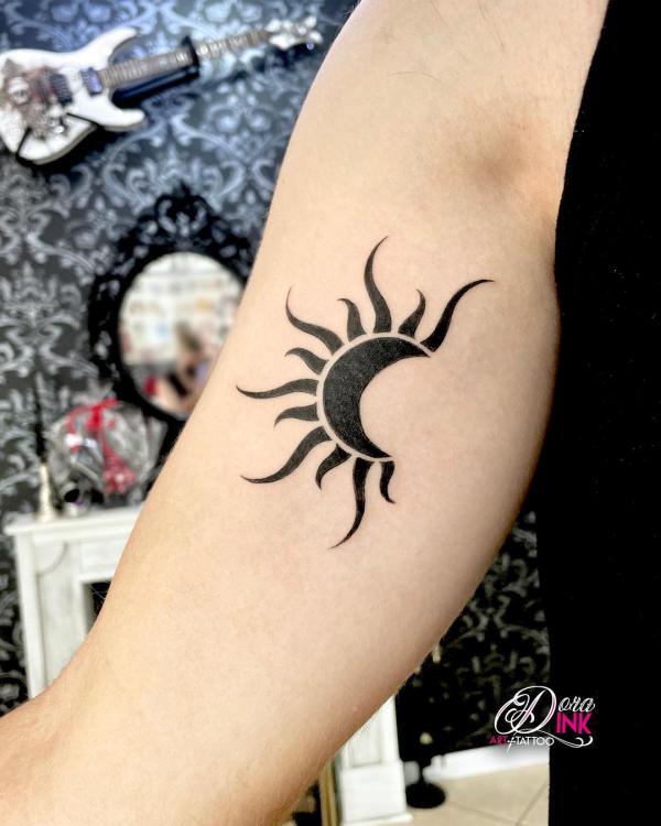 Half sun bicep tattoo
