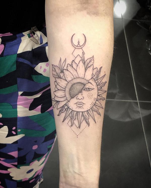 Half sunflower half sun face tattoo forearm