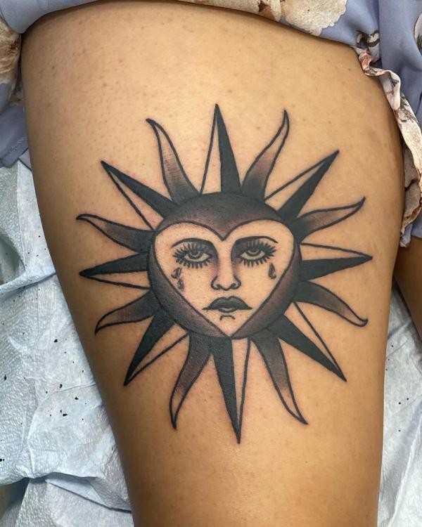 Heart sun face tattoo
