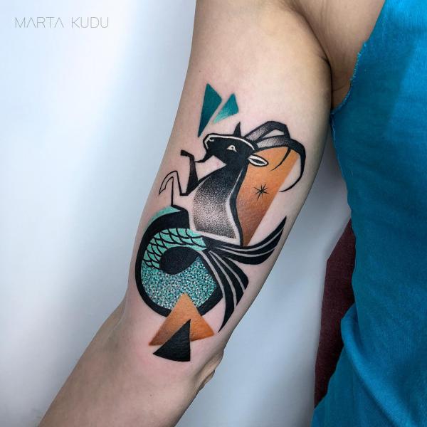 Illustrative Capricorn sea goat bicep tattoo