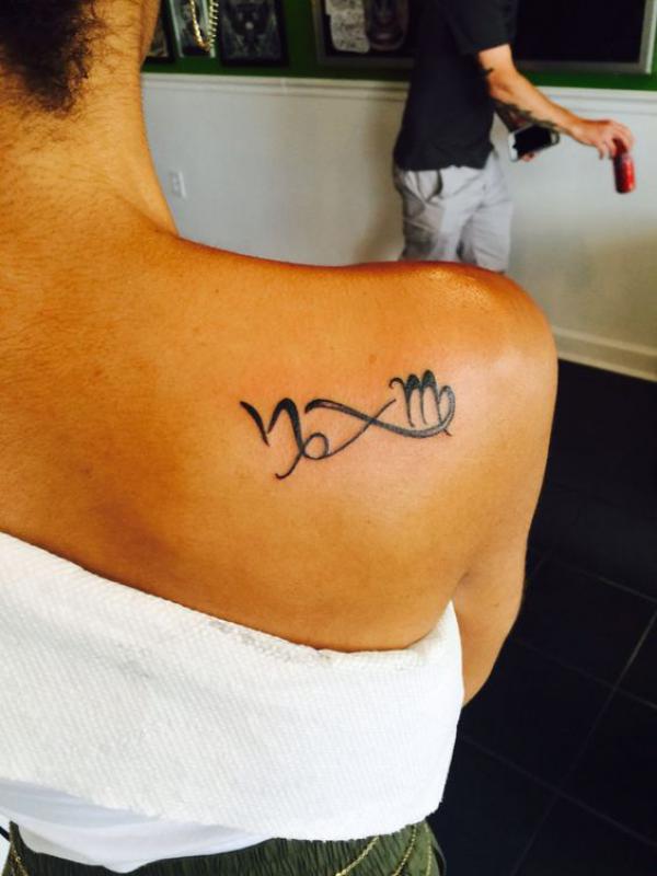 Infinity with Capricorn and Virgo signs tattoo