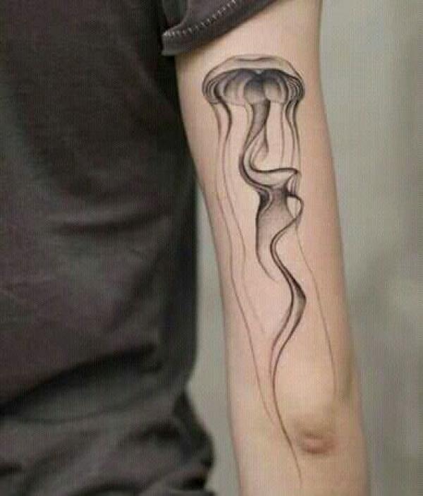 Jellyfish like smoke bak of arm tattoo