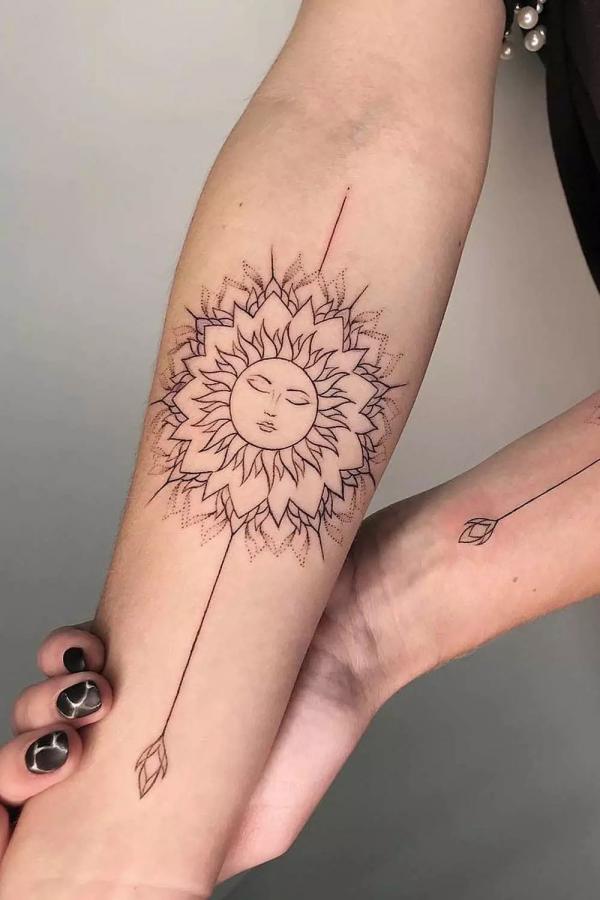 Mandala sun face tattii on forearm