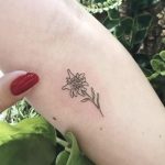 Minimalist edelweiss tattoo on arm