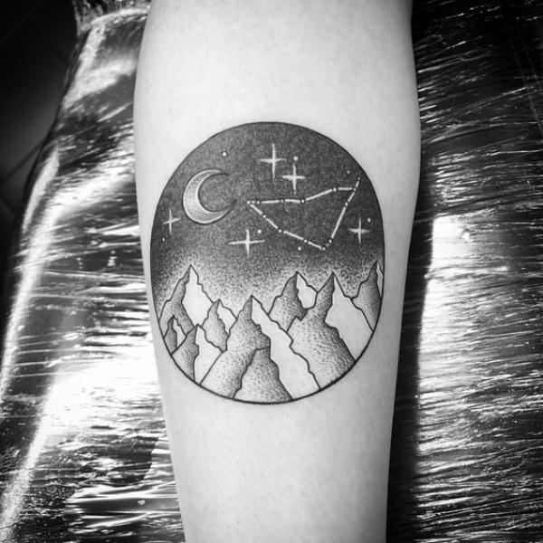 Moon and stars with Capricorn constellation and mountain tattoo