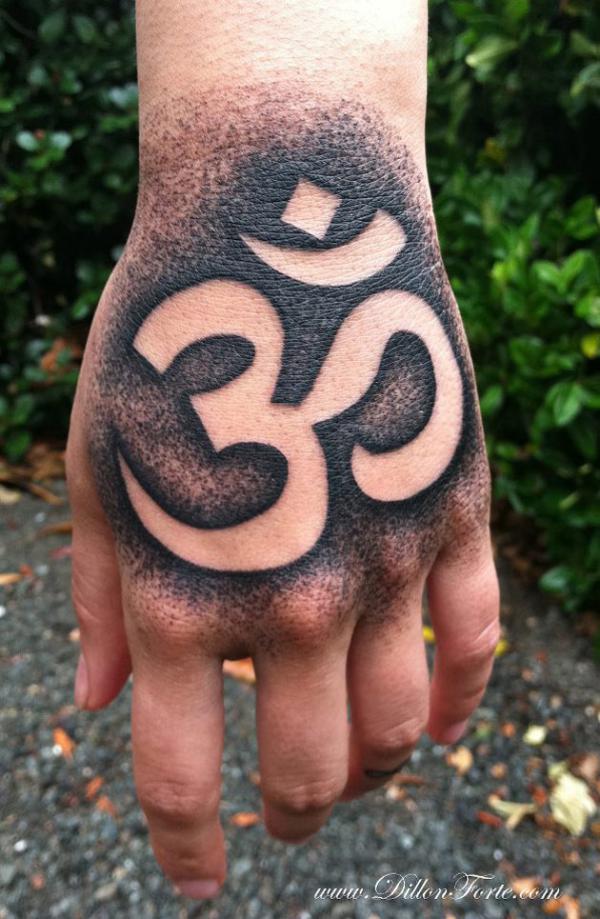 Negative space Om hand tattoo