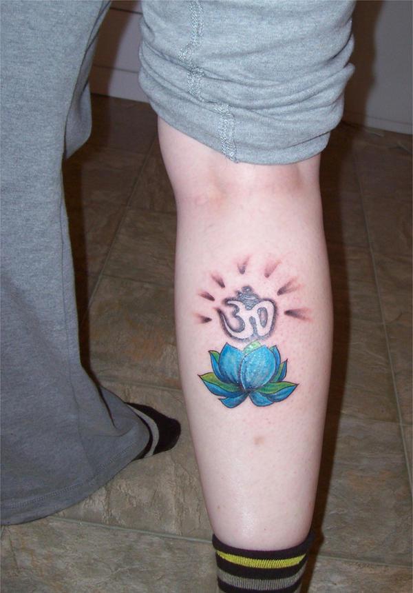 OM and blue lotus flower tattoo on lower leg