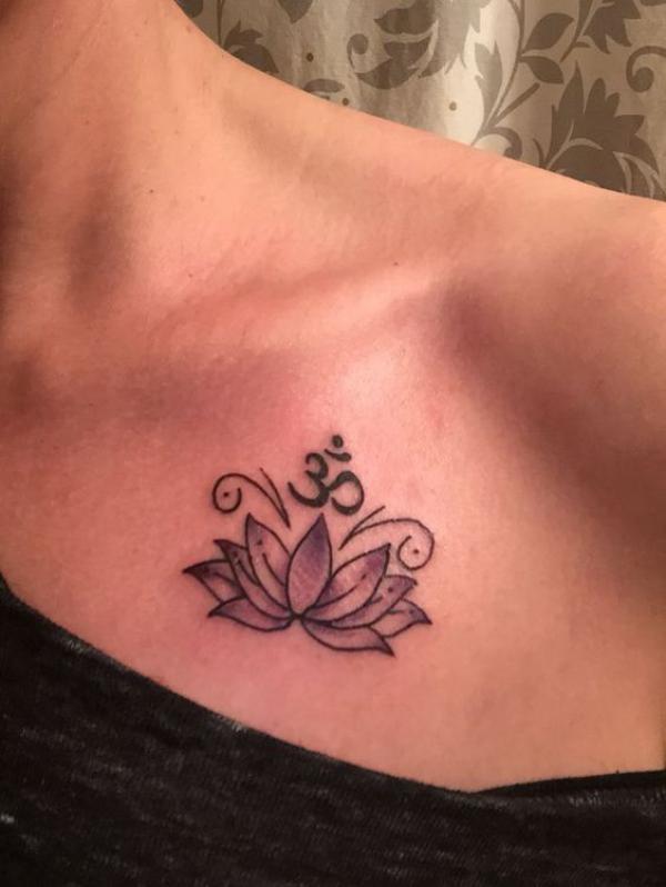 OM and lotus above boob tattoo
