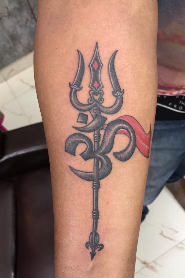 OM and trishul tattoo
