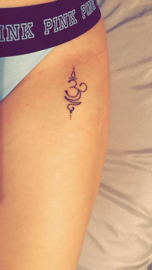 OM bikini line tattoo