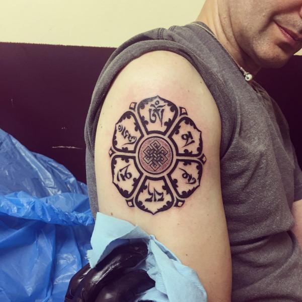 Om Mani Padme Hum tattoo upper arm