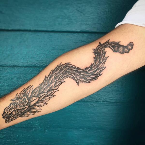 Quetzalcoatl arm tattoo