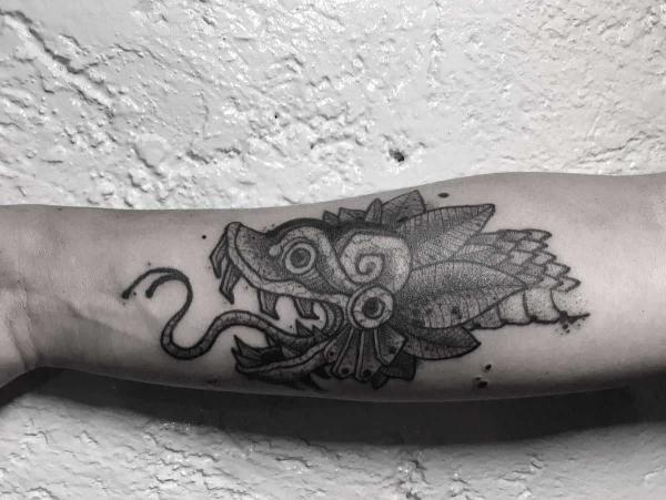 Quetzalcoatl head tattoo forearm