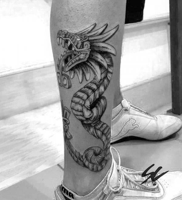 Quetzalcoatl lower leg tattoo