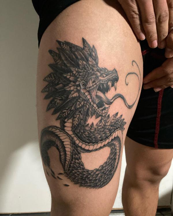 Quetzalcoatl thigh tattoo