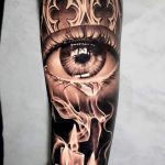 Realistic sye and candle with smoke tattoo forearm