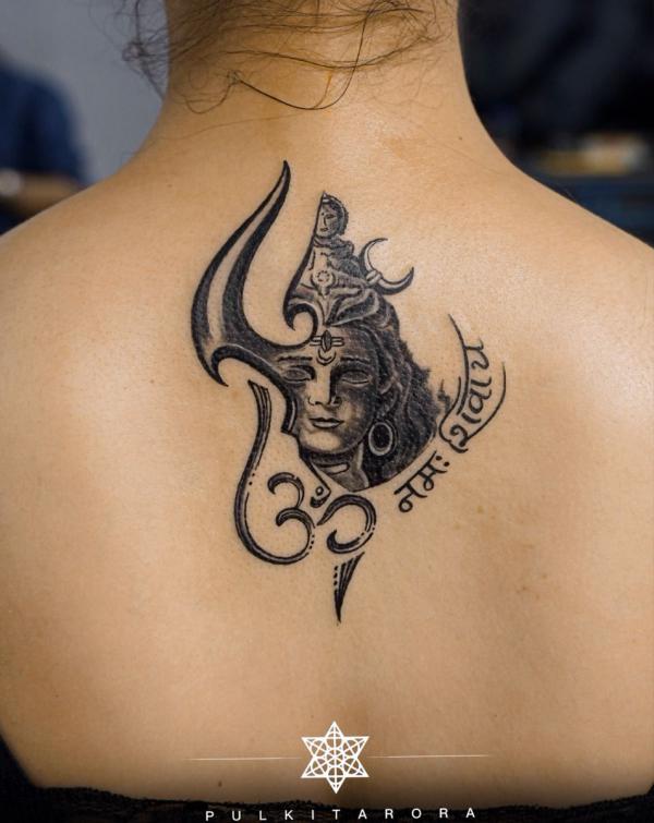 Shiva with OM tattoo on upper back