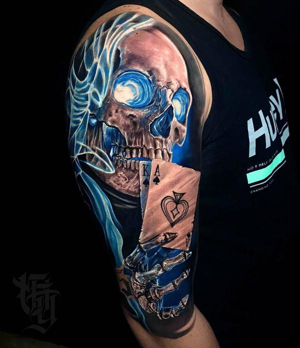 Skull and skeleton hand with Ace of spade tattoo half sleeve