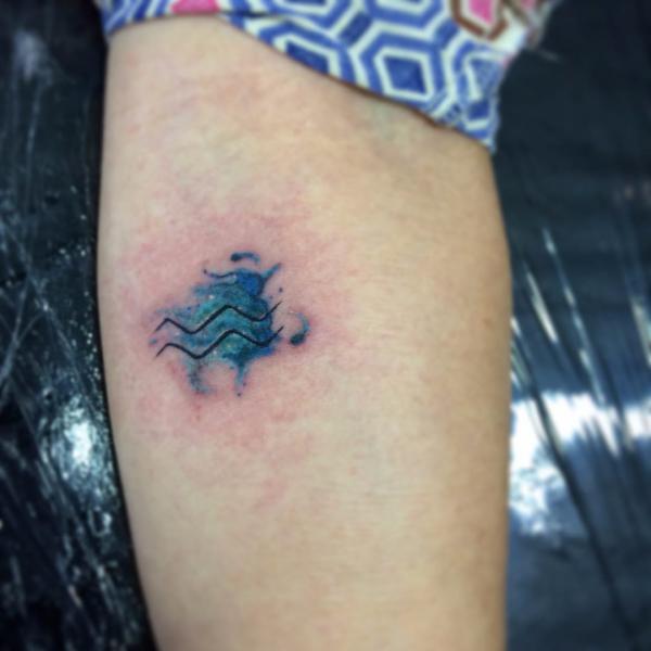 Small Aquarius glyph tattoo