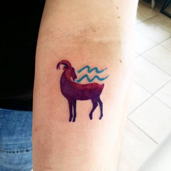 Small Capricorn goat and Aquarius sign tattoo