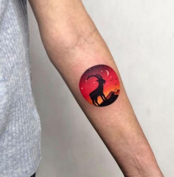 Small Capricorn goat circle tattoo forearm