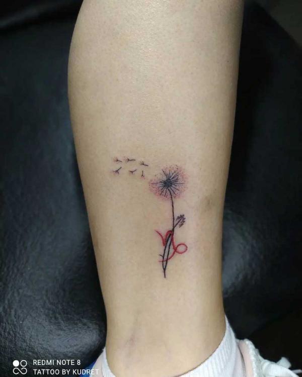 Small Dandelion with Capricorn glyph tattoo