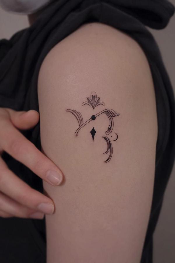 Small Floral Capricorn glyph tattoo