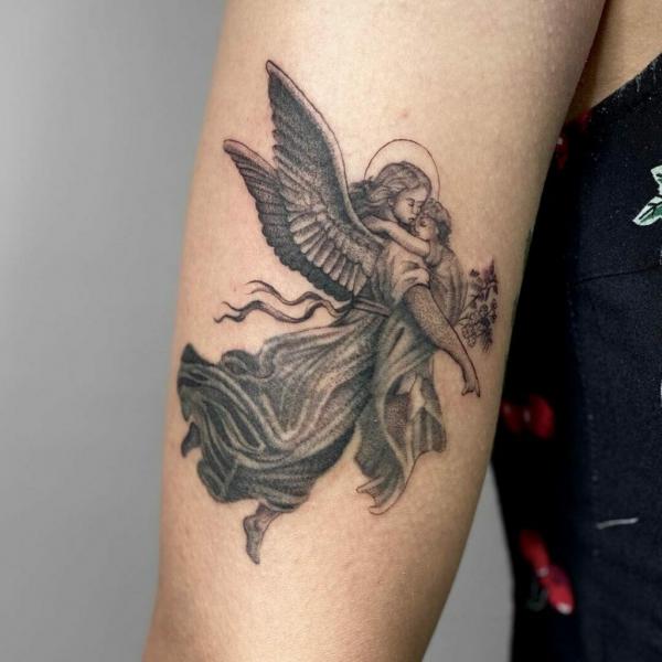 Small Guardian angel holding kid tattoo