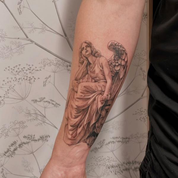 Small Guardian angel tattoo on inner forearm