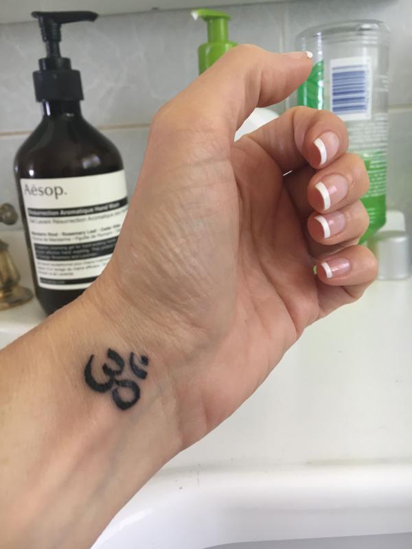 Small OM tattoo wrist