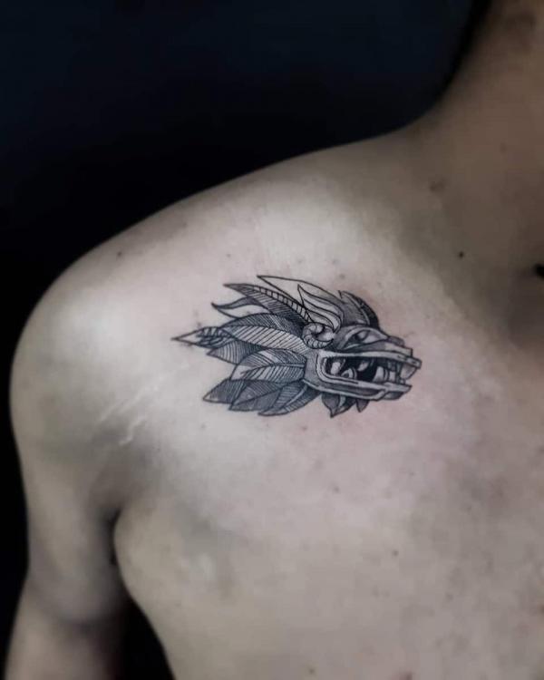 Small Quetzalcoatl clavicle tattoo