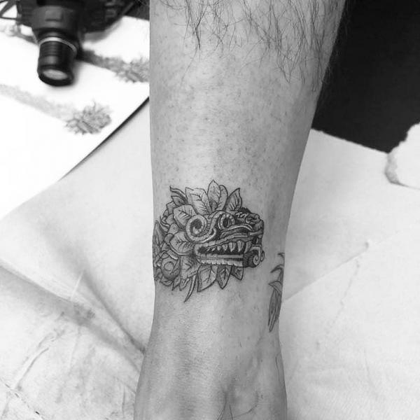 Small Quetzalcoatl tattoo above ankle