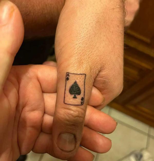 Small ace of spade tattoo on thumb