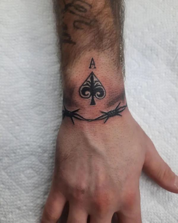 Small ace of spade tattoo wrist