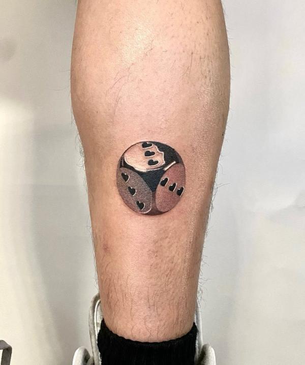 Small dice tattoo on lower leg